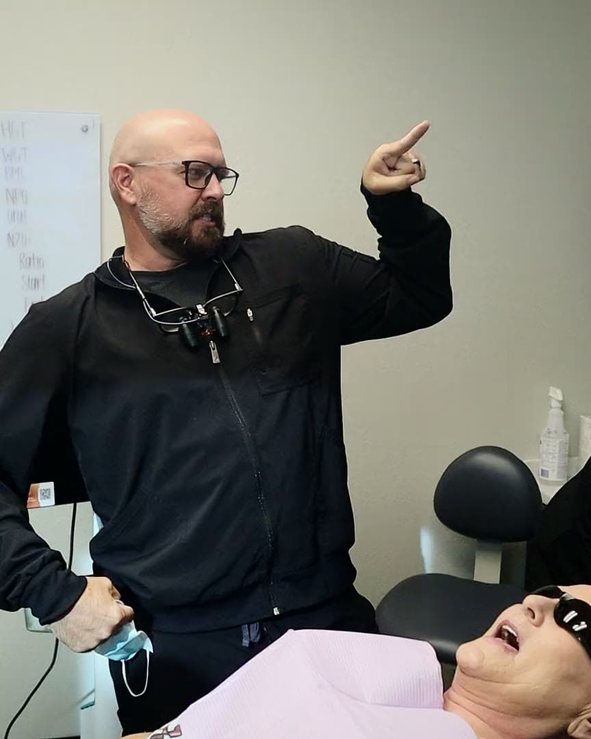 Dr. Jordon Green sharing a laugh with a patient in the treatment chair